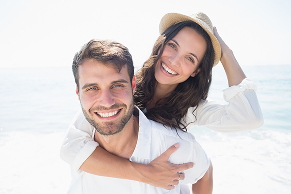 Attractive Couple Smiling On The Beach