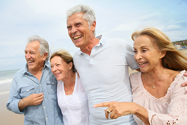 Group Of Seniors Laughing On The Beach - bone grafting services in Ponte Vedra, FL